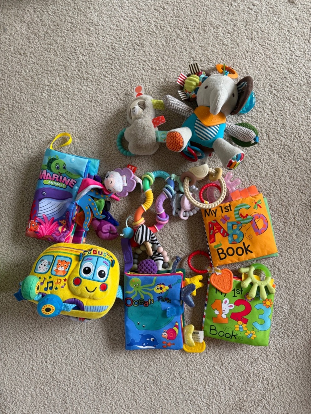 Bundle of baby soft books, teethers, baby fidgets